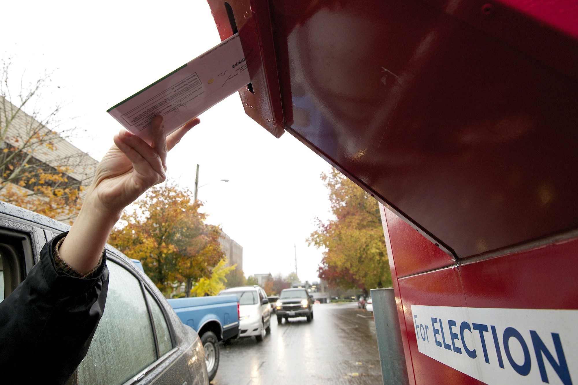 Voters use a drive-up collection box to cast their ballots in November 2013 near the Clark County elections office, 1408 Franklin St., in downtown Vancouver. They have until 8 p.m. today to drop their ballots in one of the drop boxes located throughout the county.