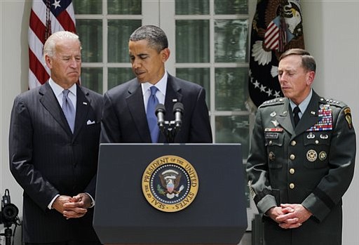 President Barack Obama, flaked by Vice President Joe Biden and Gen. David Petraeus, concludes his statement in the Rose Garden at the White House in Washington in Washington, Wednesday, June 23, 2010, where he announced that Petraeus would replace Gen. Stanley A. McChrystal. (AP Photo/J.
