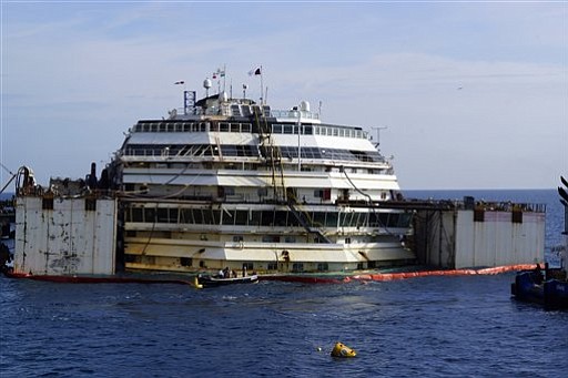 To raise the Costa Concordia, workers attached large tanks to the sides.