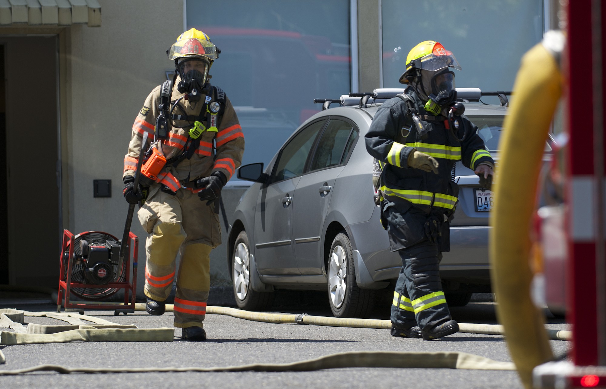 Firefighters battle a small fire Tuesday, July 15, 2014 at the Town Plaza in Vancouver, the former Tower Mall. The fire was reported around 1:30 p.m. at 5411 E. Mill Plain Blvd., which houses social services.