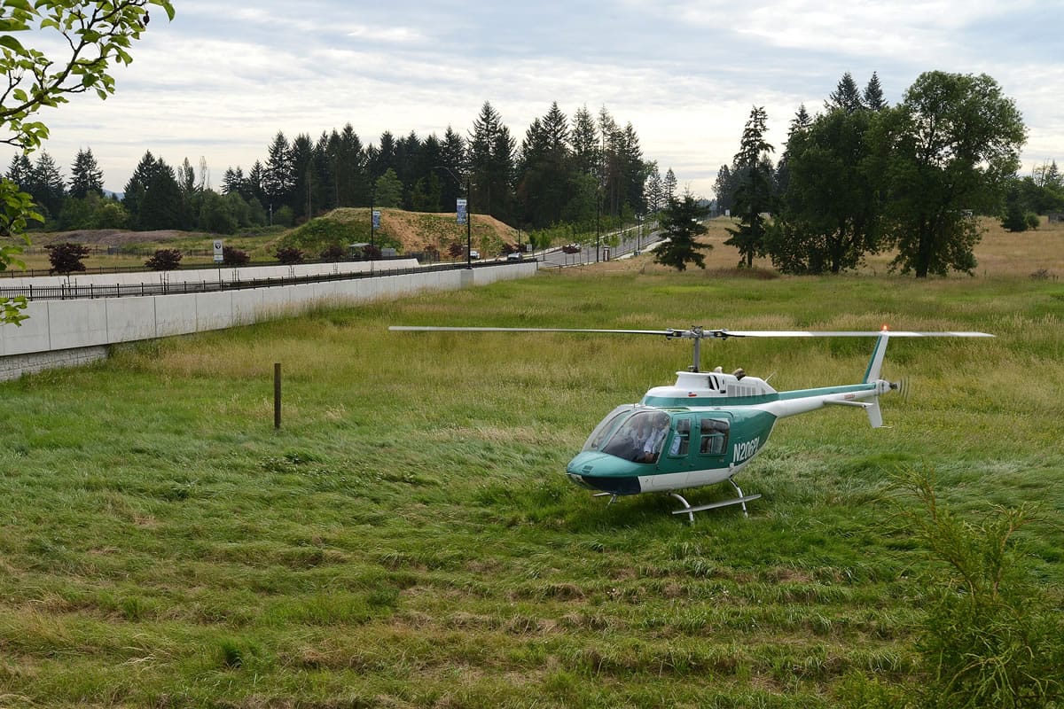 A helicopter sits where it landed Wednesday morning in a wetlands area near the 19400 block of Southeast 192nd Avenue in Vancouver.