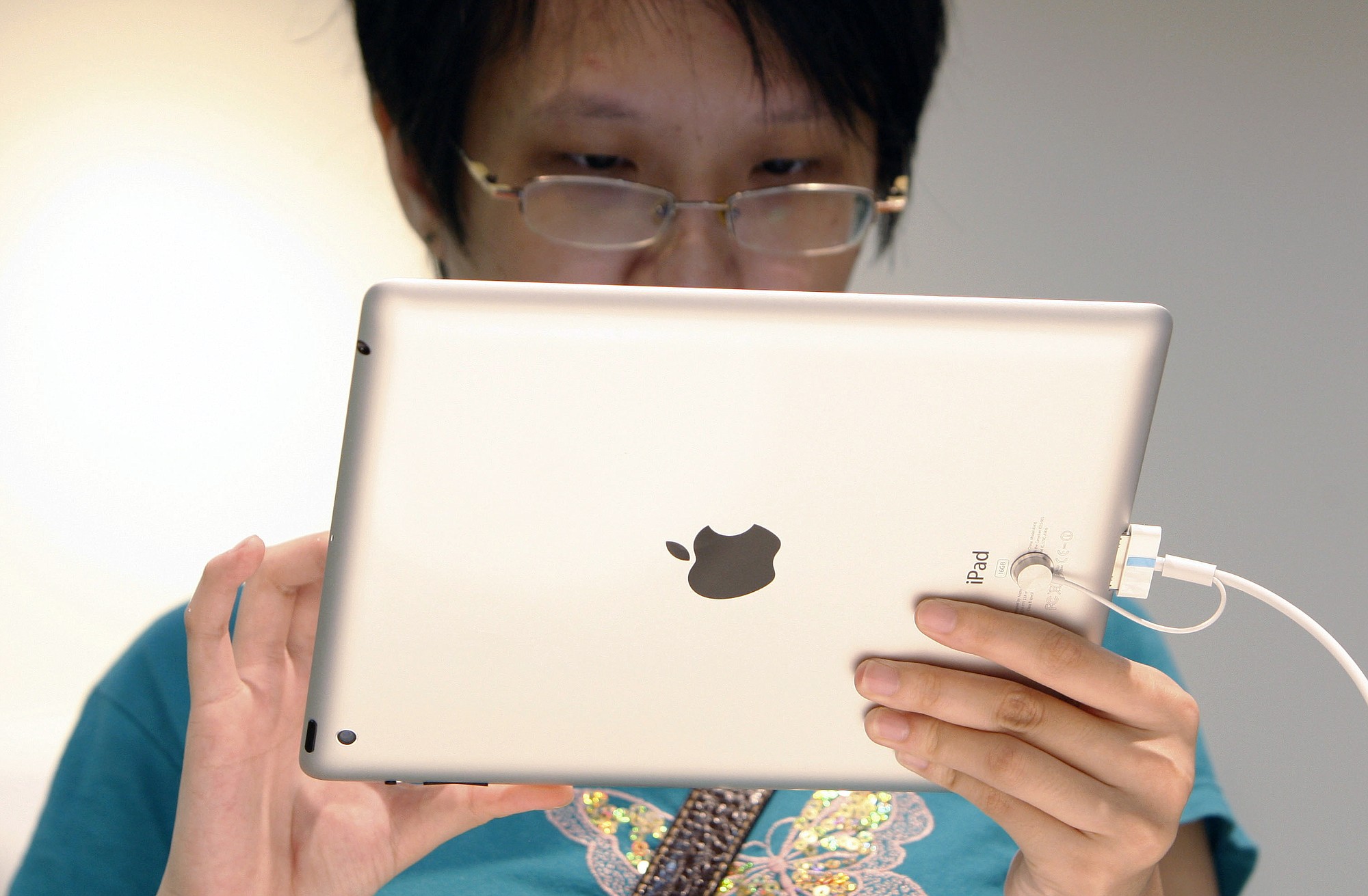 A visitor tries out an iPad at an Apple store in 2012 in Klang, outside Kuala Lumpur, Malaysia. IPads and other other electronic devices containing nickel might cause rashes, according to a Monday report in Pediatrics.