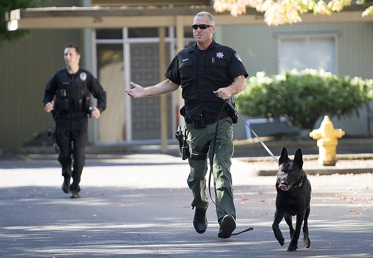 Clark County Sheriff's Deputy Rick Osborne and his K-9 Kane search for a bank robbery suspect in September.