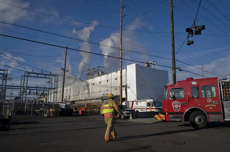 Fire crews respond to a fire on the roof of a building at the Georgia-Pacific paper mill in Camas on Thursday.