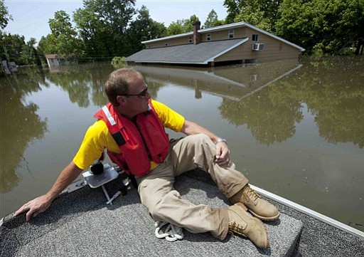 Deputy Mike Traxler views flooded homes in Vicksburg, Miss., Wednesday, May 18, 2011. Floodwaters from the Mississippi river are expected to crest in Vicksburg on Thursday. Some of the worst flooding is in the area from Vicksburg northeast to Yazoo City, along the Yazoo River. The Yazoo Backwater Levee north of Vicksburg connects with the main Mississippi River levee. The Corps of Engineers officials had predicted that at least a foot of water could pour over the top of the levee, flooding tens of thousands of more acres of farmland in the lower Mississippi Delta.