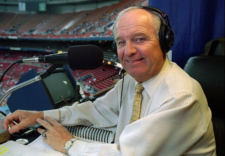 In this May 1, 1999, file photo, longtime Seattle Mariners broadcaster Dave Niehaus sits in his booth at the Kingdome before a baseball game.