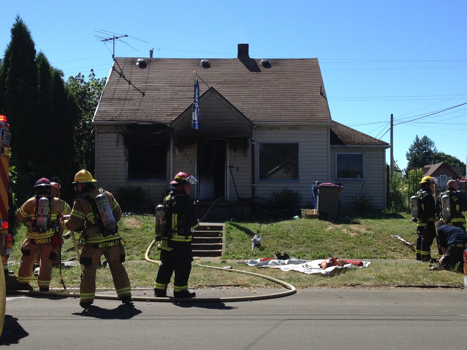 Vancouver firefighters work to mop up a house fire at 30th and N streets this afternoon.