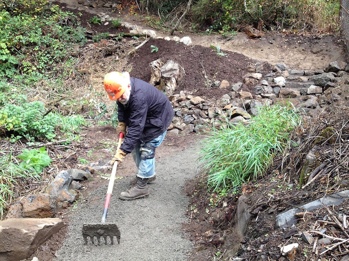 Longtime volunteer Ted Klump puts the finishing touches on the River to Rock Trail, a new connector path that links the day-use area to the trail to the top of Beacon Rock State Park.
