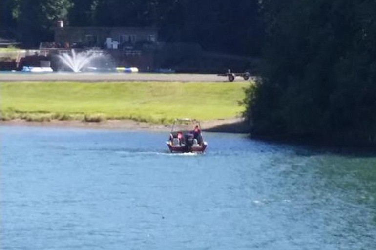 Emergency crews respond to the Lewis River south of Woodland, where a teenage boy presumably drowned Sunday after trying to swim across the river with his friends.