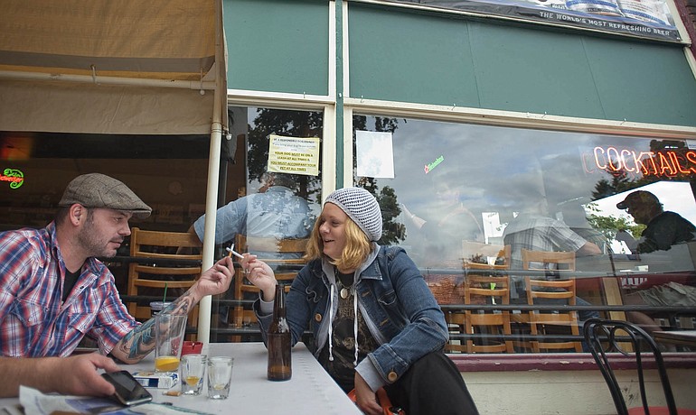 Tip Top Tavern patrons Joe Graham and Summer McClintock, both of Vancouver, toast after lighting up cigarettes on Wednesday.