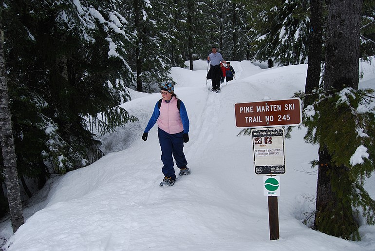 Snowshoers walk along Pine Martin trail on the south side of Mount St.