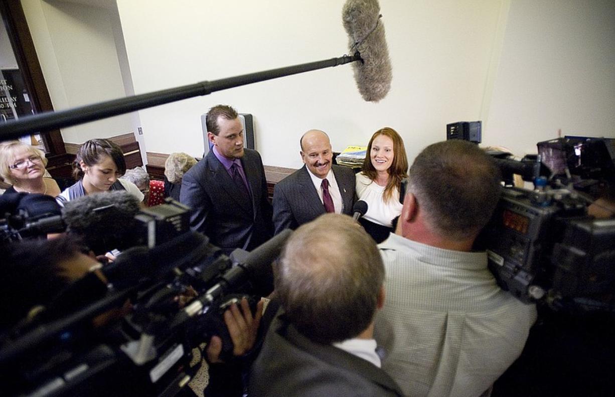Clyde Ray Spencer, center, talks to the media at the Clark County Courthouse after charges related to the sexual abuse of his children, Matt Spencer, left, and Katie Tetz, were dismissed on Wednesday.