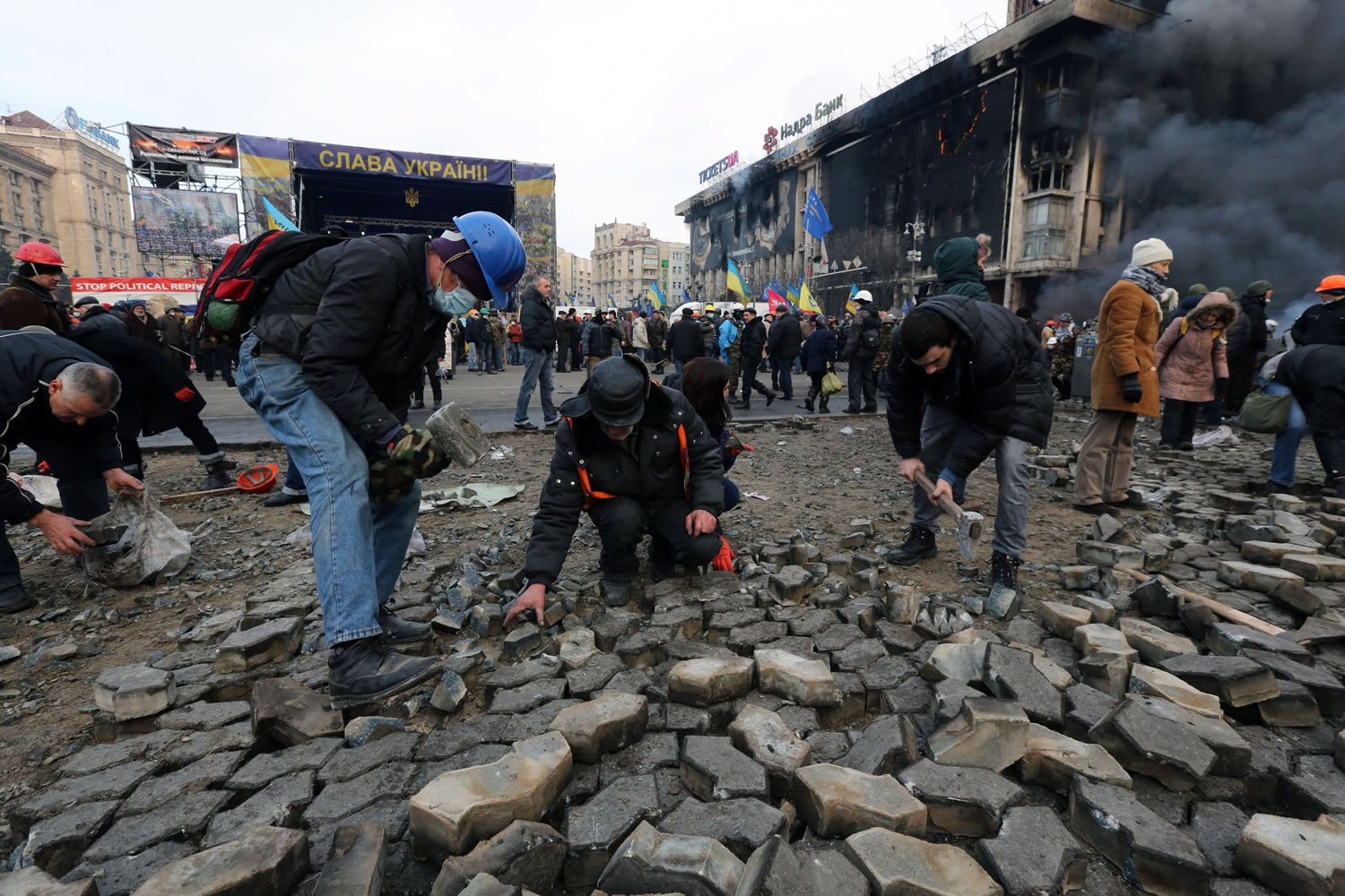 Protesters dig cobblestones out of the Independence Square surface to hurl at police in Kiev, Ukraine, on Wednesday.