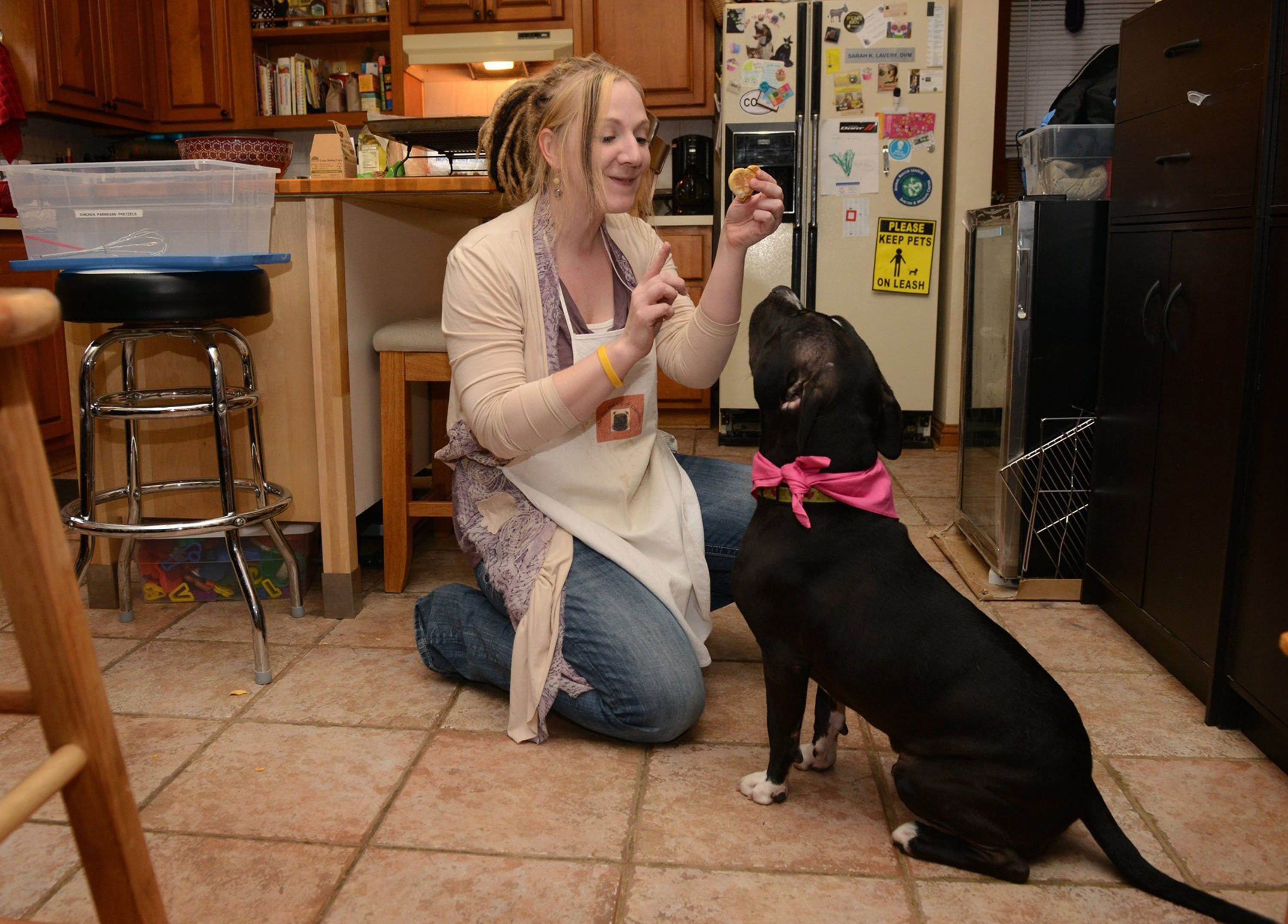 Veterinarian Sara Lavery has her pit bull, Arya, wait for one of her homemade treats in her Oakmont, Pa., kitchen.
