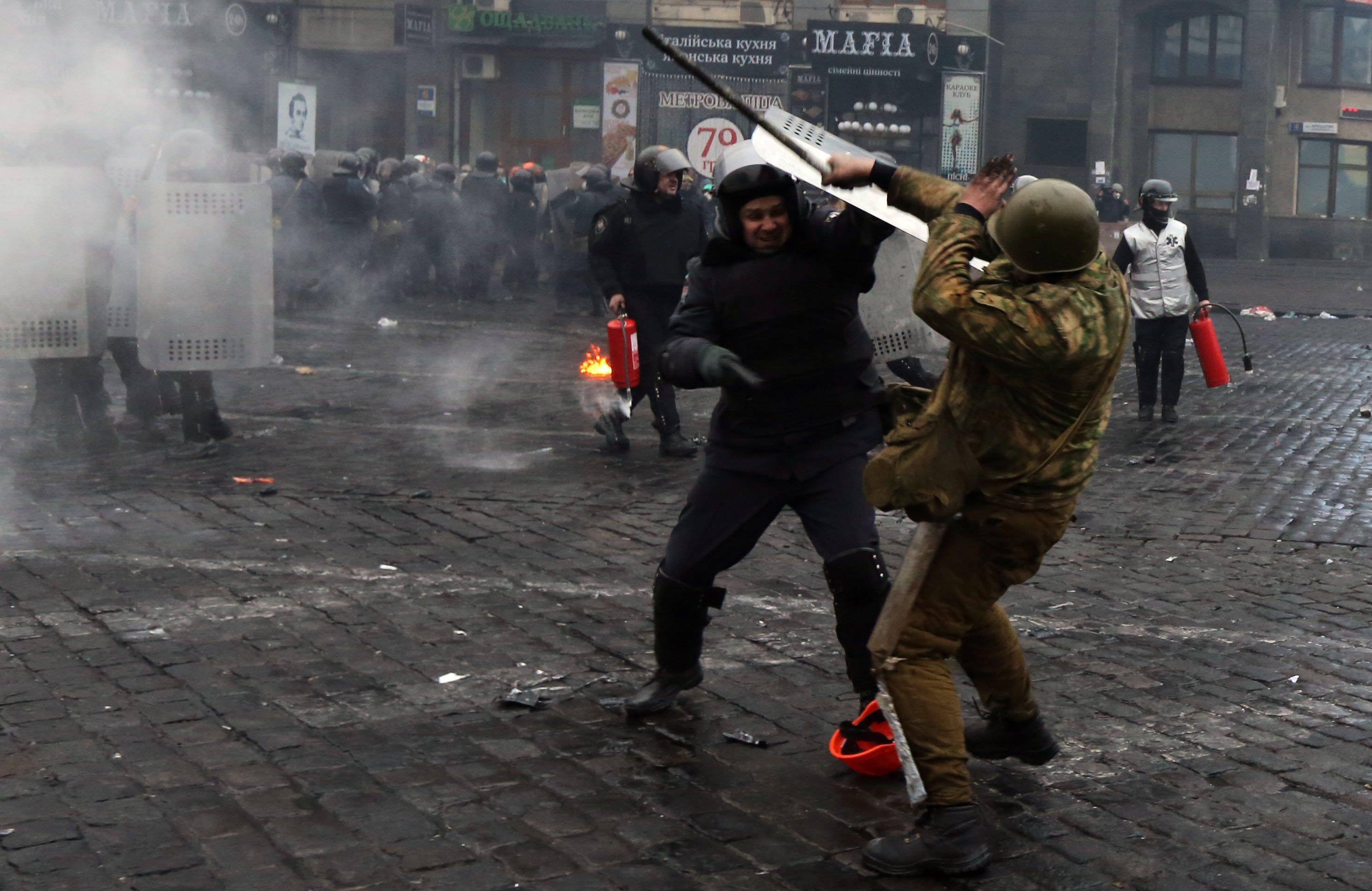 Protesters clash with police in central Kiev, Ukraine, on Thursday.
