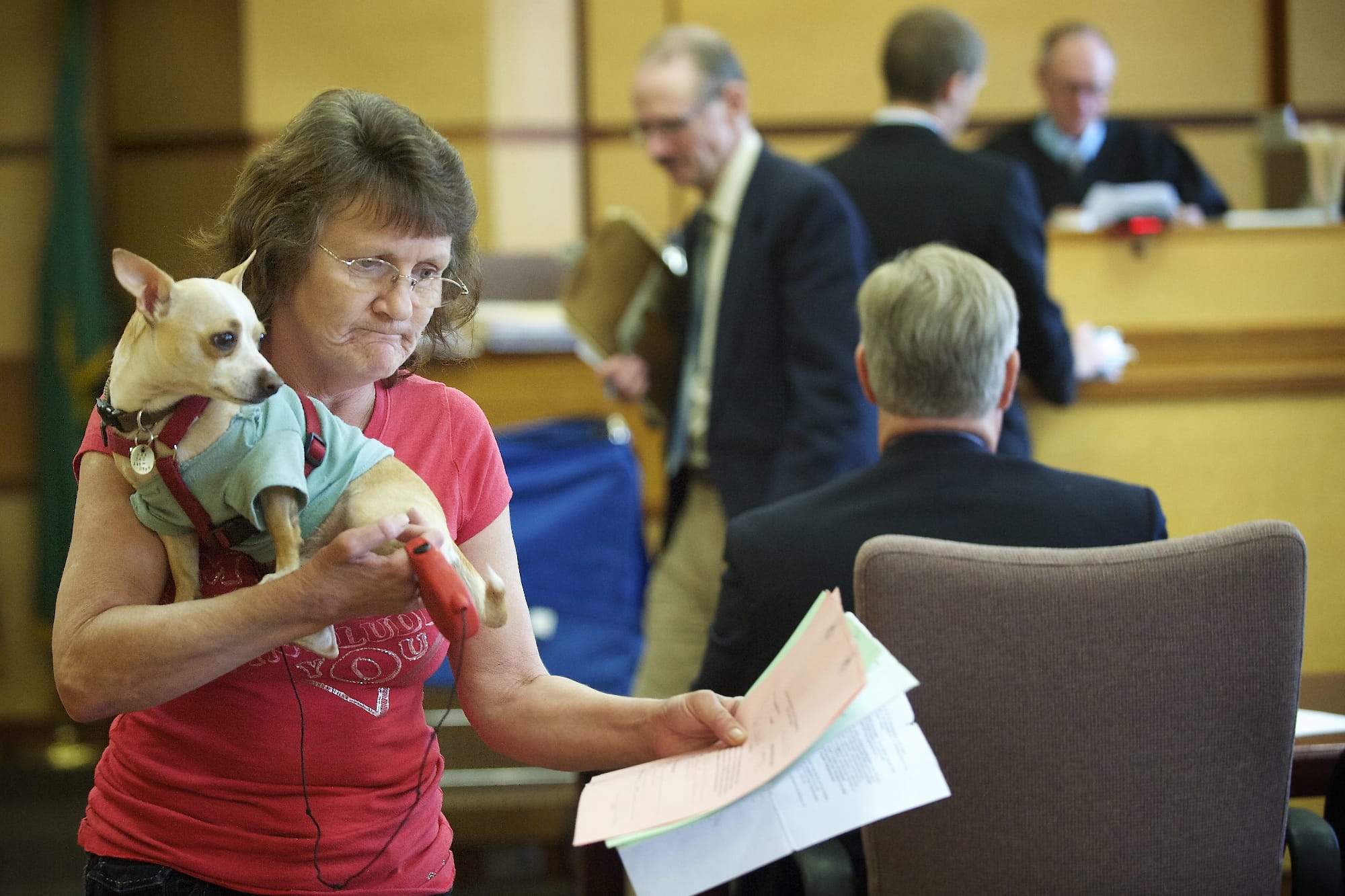Hazel Trent of Vancouver leaves a Clark County courtroom May 14 with her service dog, Max.