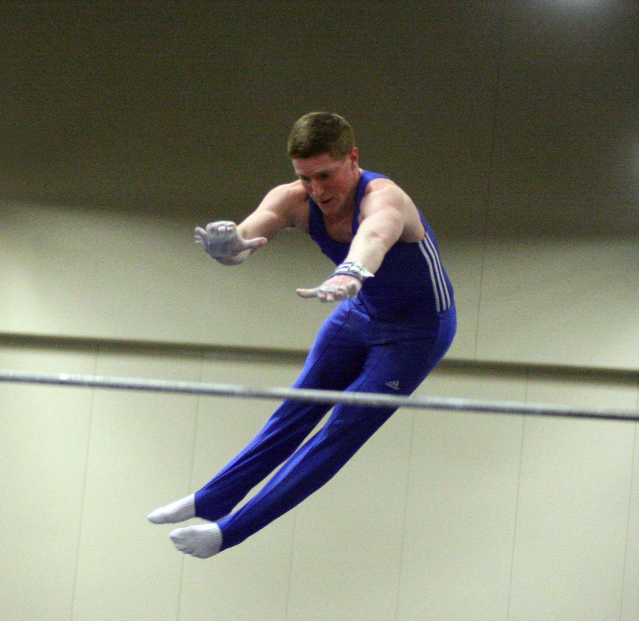 VEGA's Trace Jacquot, of Hockinson, flings himself over the high bar and catches it on the other side during the Level 10 USAG Washington state men's gymnastics meet Saturday, at the Clark County Event Center.