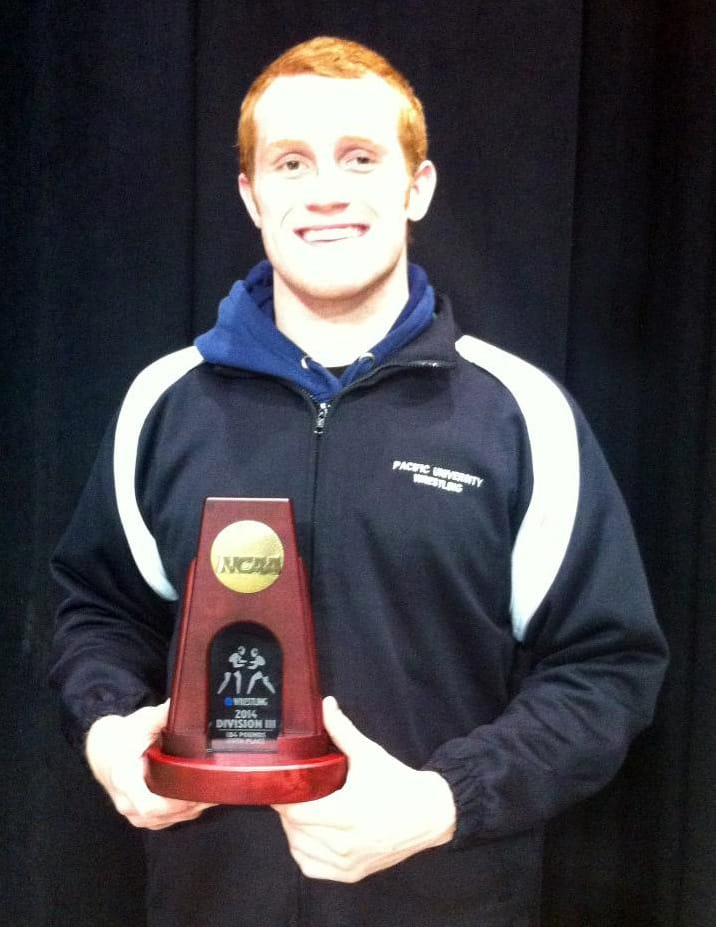 Camas wrestler Caleb Malychewski holds his fifth-place trophy from the NCAA Division III championship tournament.
