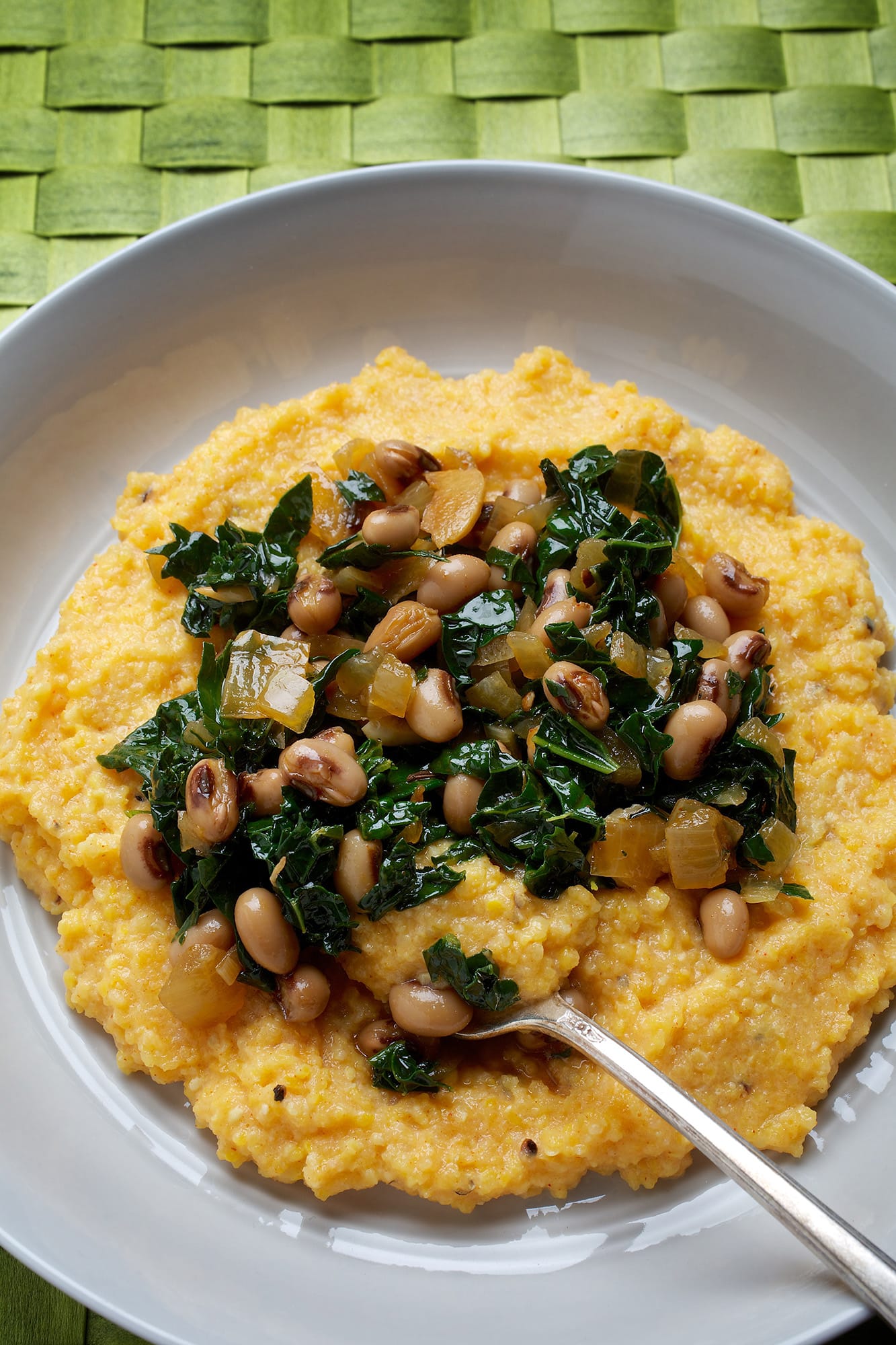 Kale pairs with black-eyed peas and smoky grits for a hearty dish with a Southern twist.