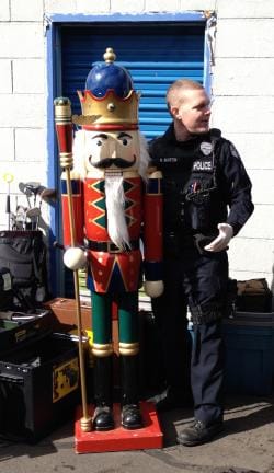 Vancouver police Cpl. Neil Martin, right, stands with a 6-foot nutcracker recovered from a storage unit.