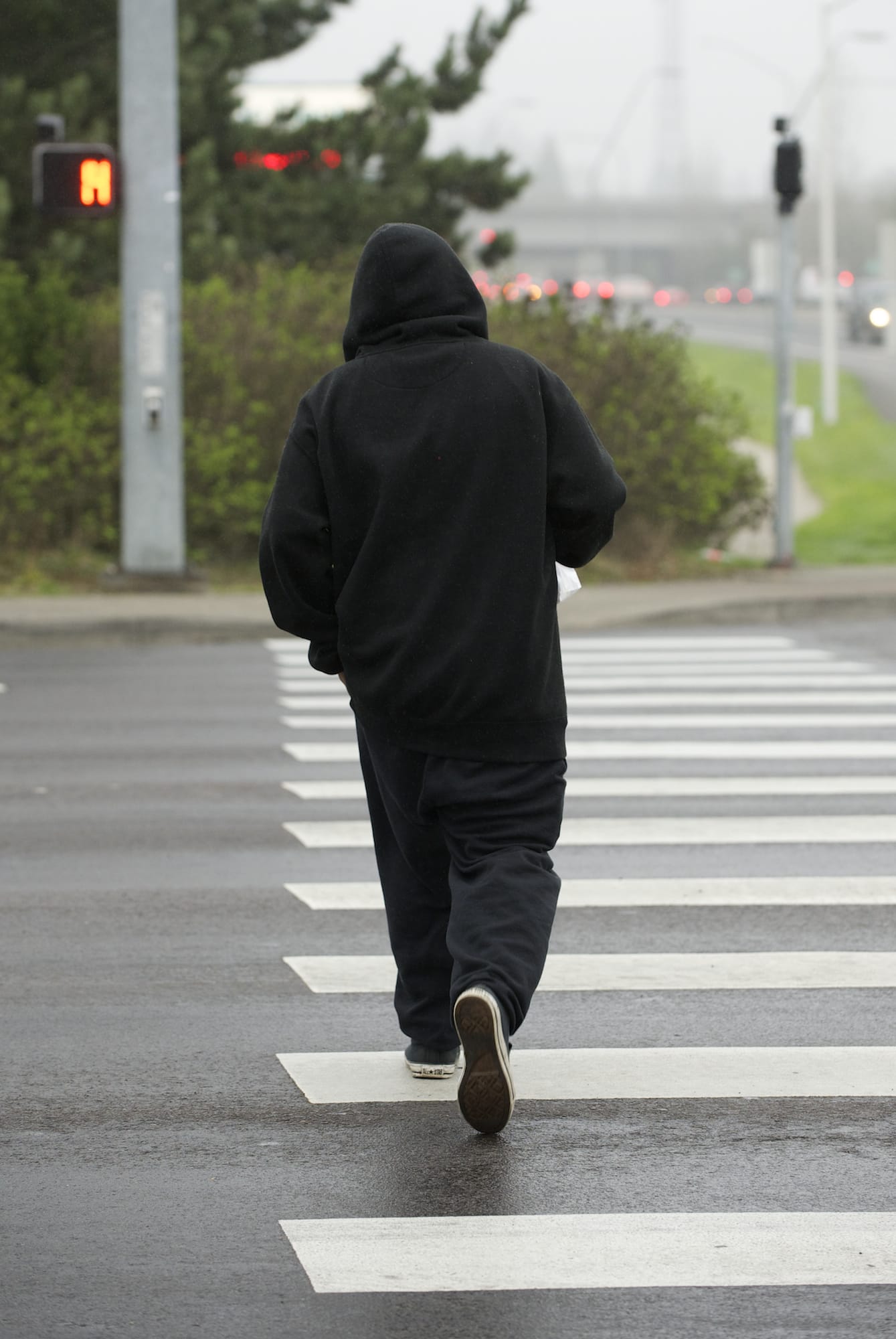 A pedestrian crosses Fourth Plain Boulevard at Andresen Road in Vancouver.