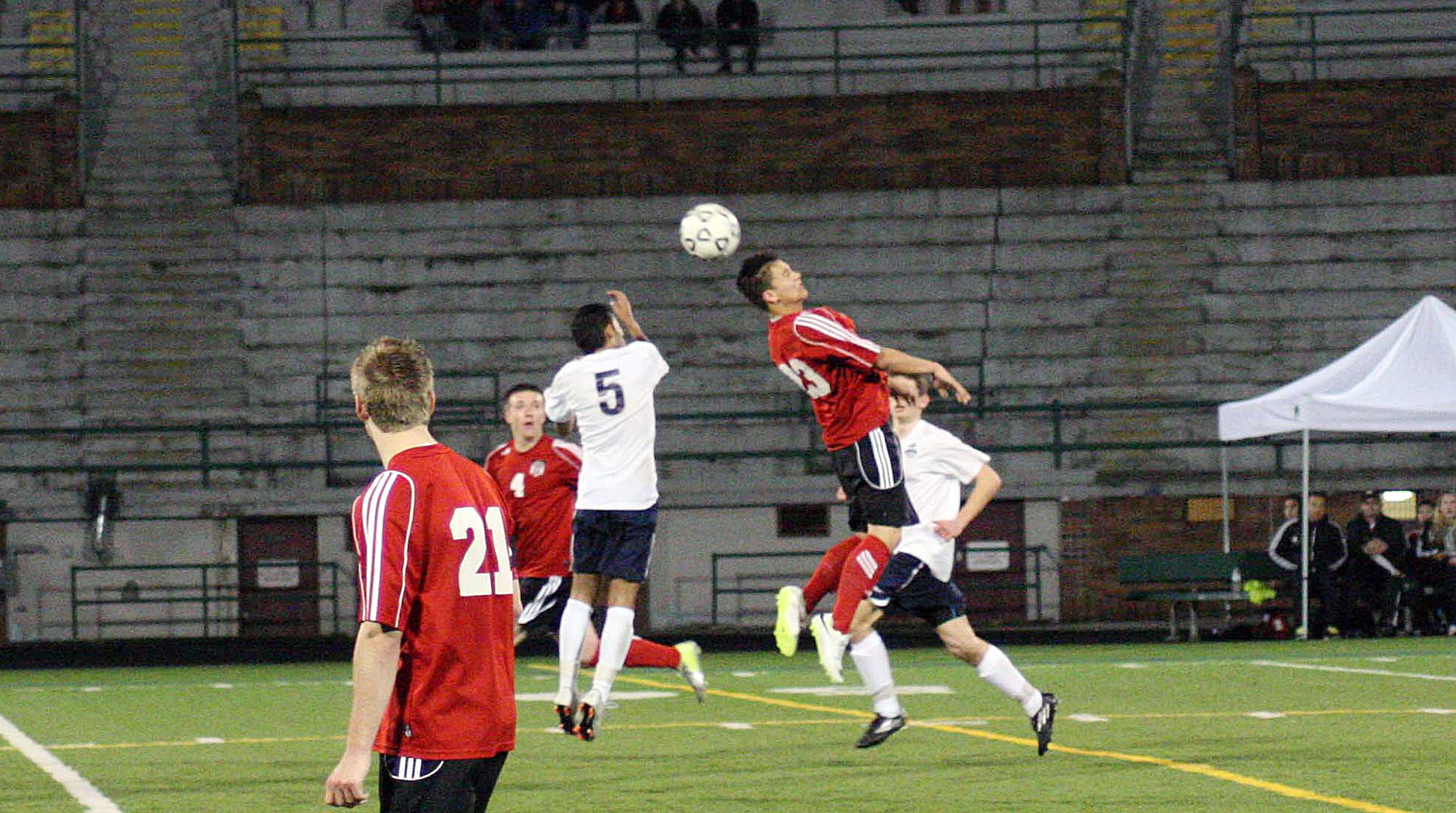 Camas forward Cameron Eyman heads the soccer ball beyond a Skyview defender during overtime April 1, at Kiggins Bowl.