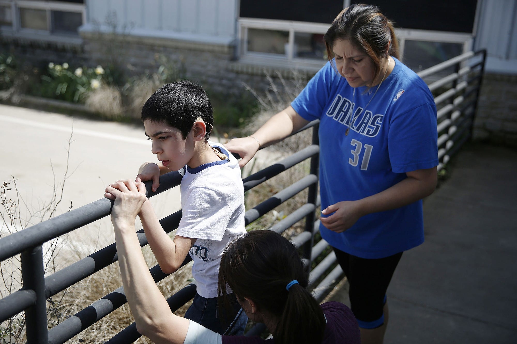 Laura Lopez, top right, watches as therapist Kristi Immitt helps her son, Jonathan Lopez, 7, of Rockwall, Texas, who has cerebral palsy, perform an exercise following his hippotherapy session at Equest on March 31, 2015 in Rowlett, Texas. Lopez has been attending Equest for one year.