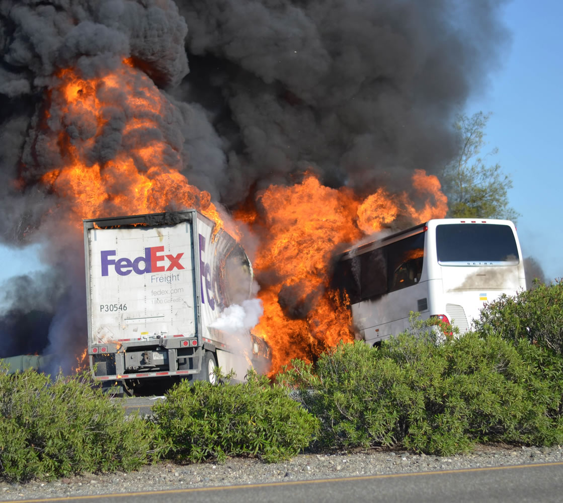 Flames engulf a tractor-trailer and a bus just after they collide Thursday on Interstate 5 near Orland, Calif.