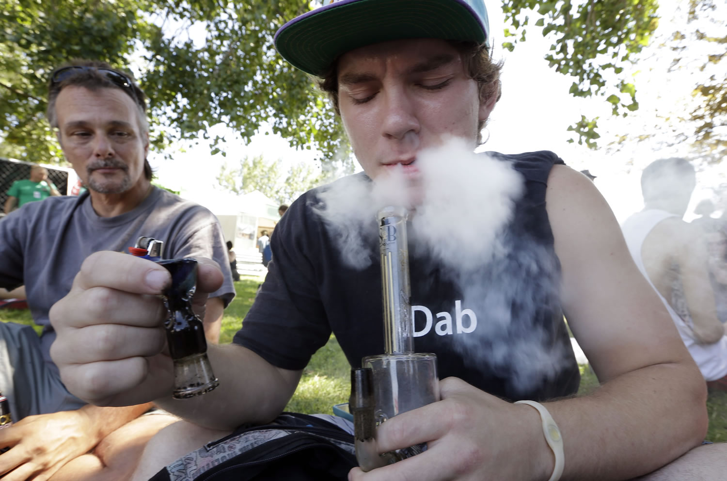 Files/Associated Press
Cody Park exhales a cloud of marijuana smoke at Seattle's Hempfest in 2013. It's not yet clear whether legalization will bring more opportunities for research into the plant's effects or medicinal value.