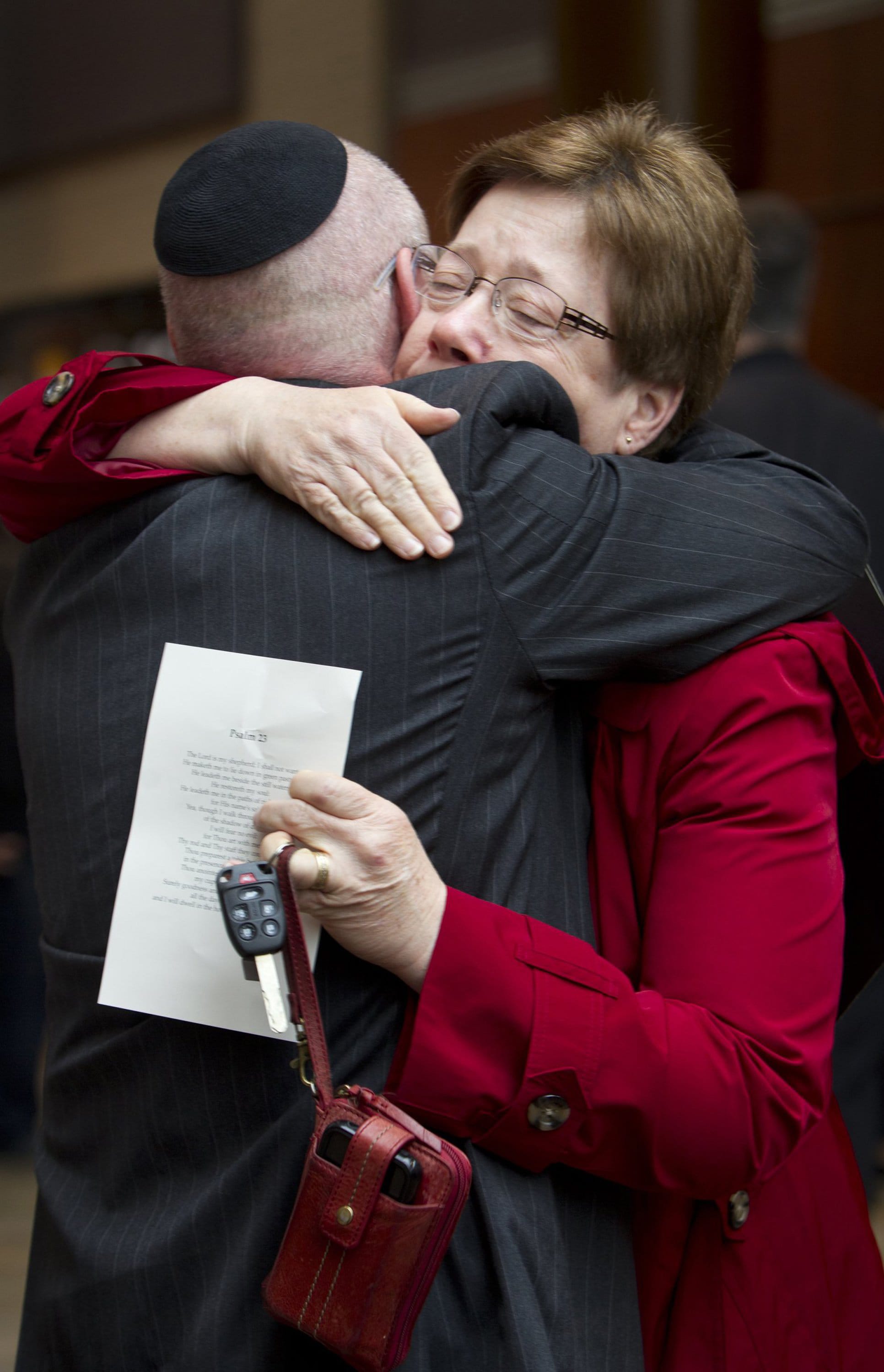 Rabbi Arthur Nemitoff of The Temple, Congregation B'nai Jehudah, left, and Sue Thompson of Church of the Resurrection hug Thursday at a service in Overland Park, Kan., for victims of Sunday's shooting.