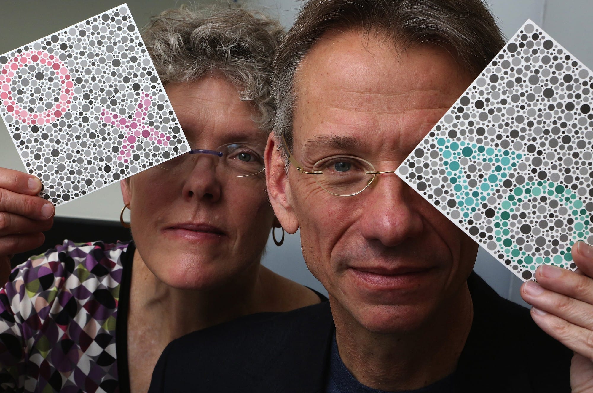University of Washington researchers Maureen and Jay Neitz, seen holding testing cards for color perception, have teamed up with a California biotech company for a prospective gene-therapy cure for colorblindness.