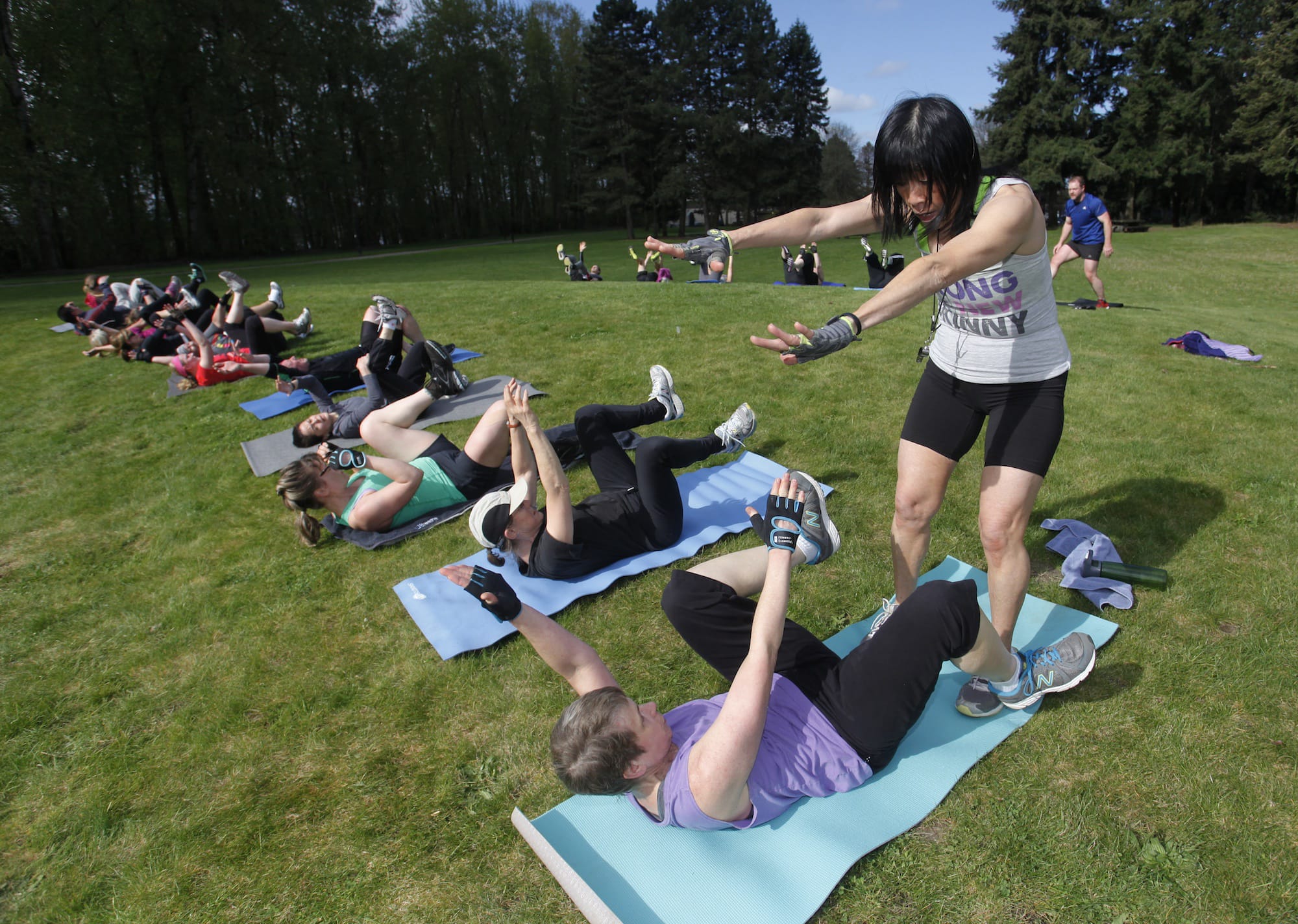 Photos by Steve Dipaola for The Columbian
May Jackson leads participants through her Be Fit Club boot camp class at Marine Park in Vancouver. Jackson hosts free boot camp classes every Saturday morning at various locations in Clark County.