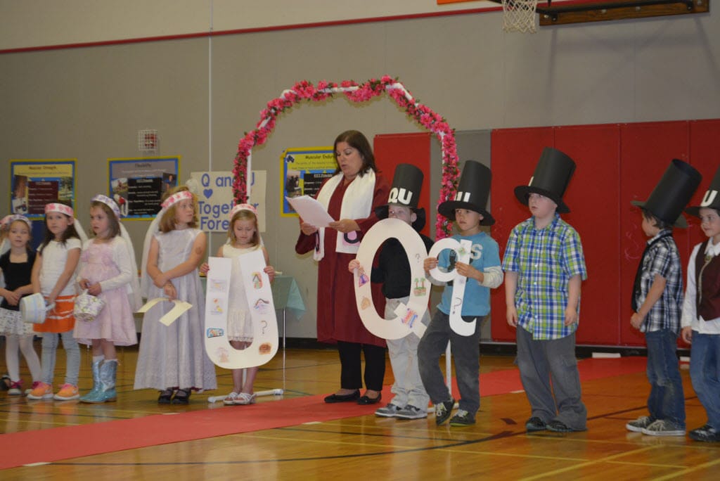 Washougal School District
Hathaway Elementary School kindergartners Rylee Quinn, as Miss U, and Wyatt Brannan, as Mr. Q, take part in a &quot;marriage&quot; of the two letters with their class. The ceremony was officiated by Principal Laura Bolt, center.
