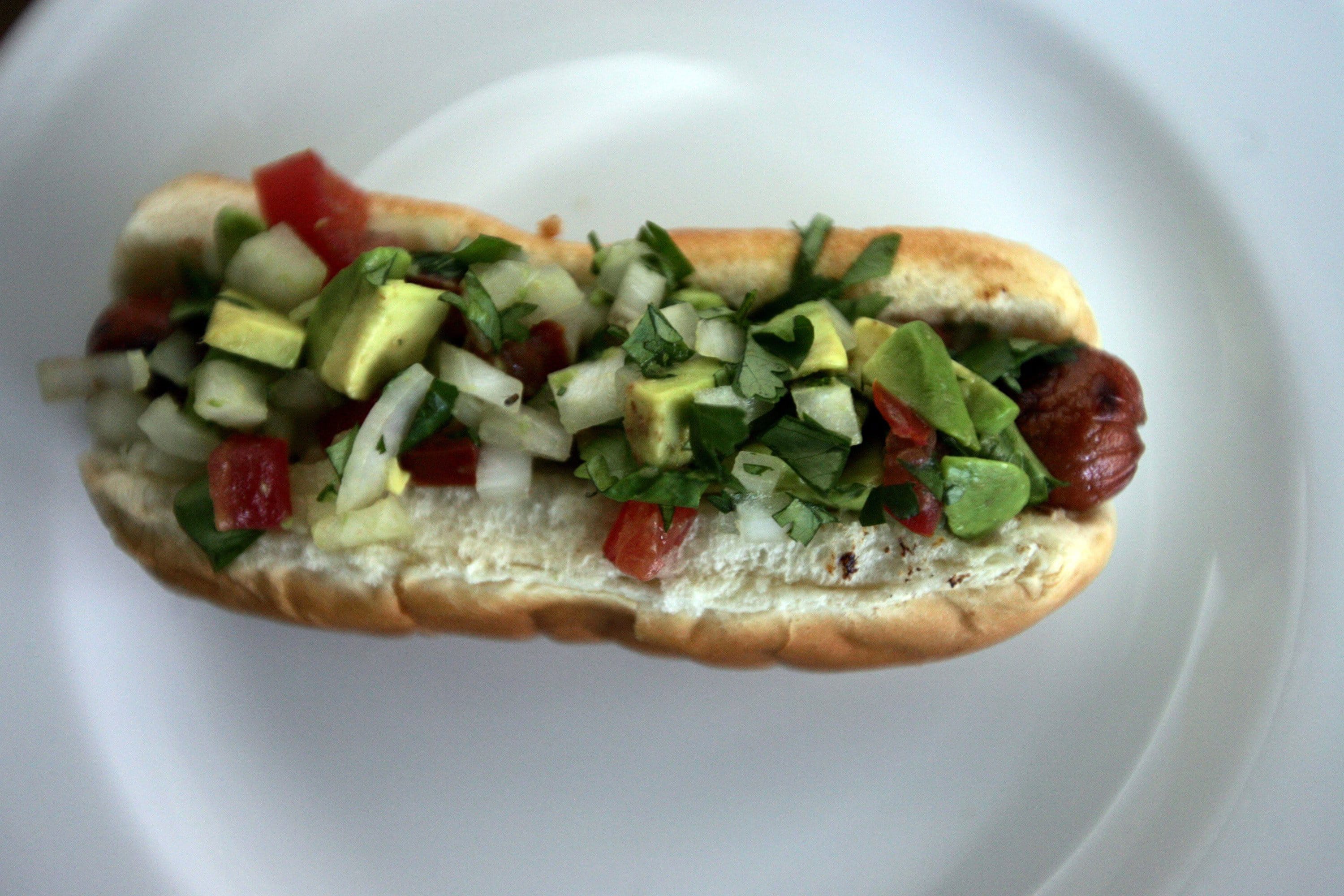 An avocado and spicy relish can dazzle during hot dog season.