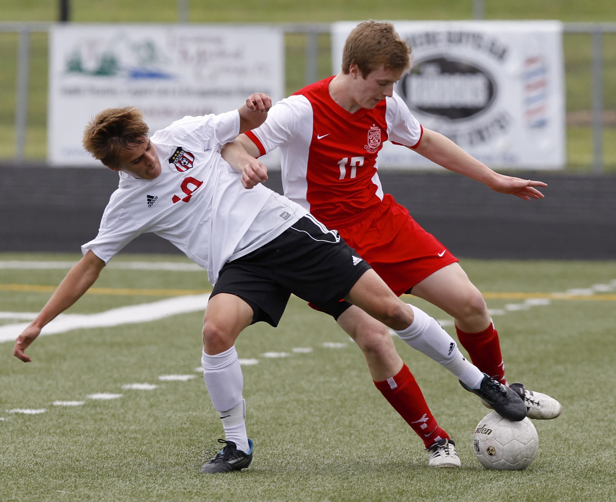 Camas defender Sam Pizot, left, battles with Ferris forward Eric Hollenbaugh in 4A state quarterfinal game Saturday at Doc Harris Stadium. Hollenbaugh scored Ferris' first half goal and the winning penalty kick following overtime to eliminate the Papermakers from the state tournament.
