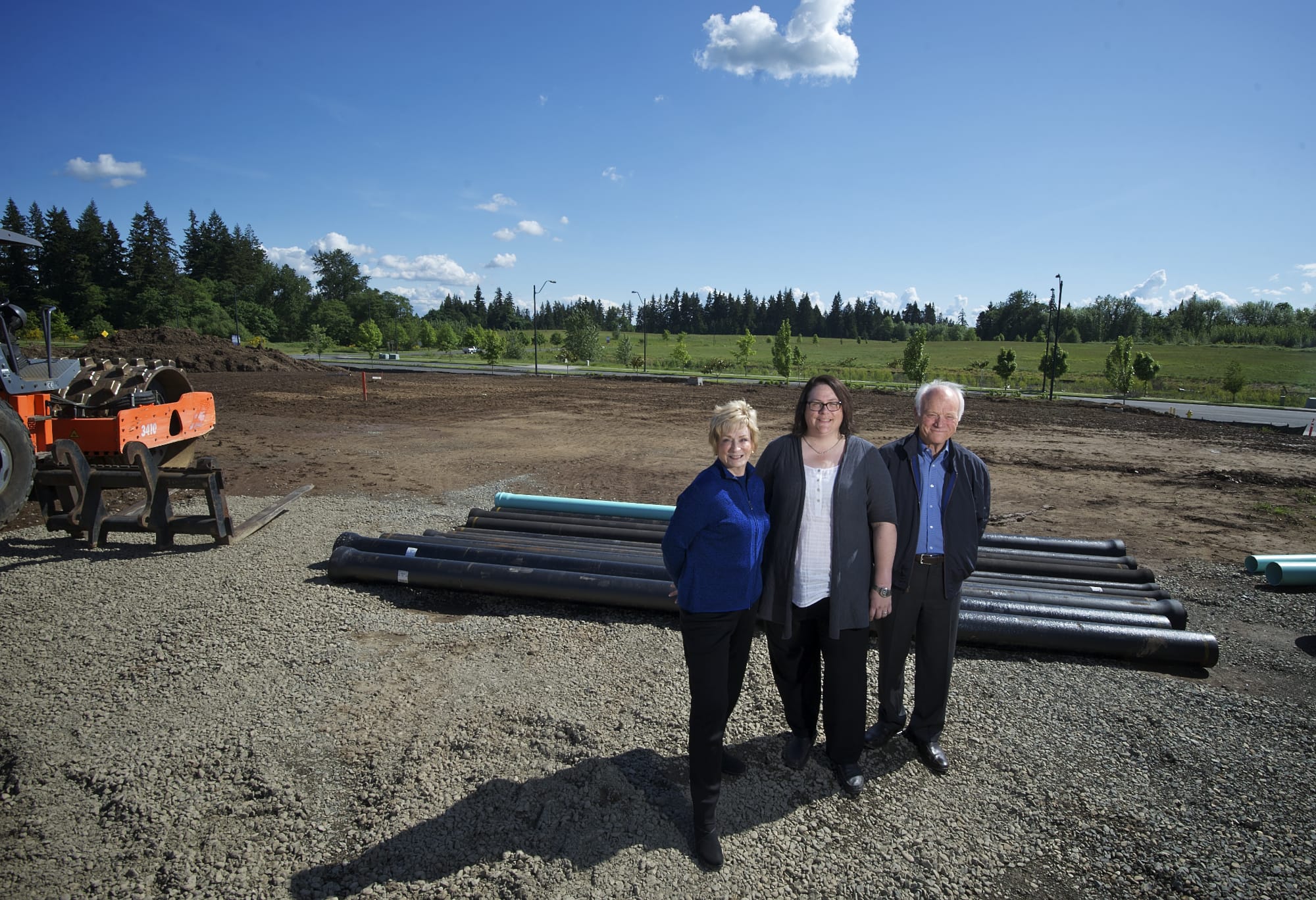Kris Vockler, center, chief executive officer of Vancouver-based ICD High Performance Coatings, and her parents, Patricia and Larry Vockler, company founders, visit the Ridgefield construction site where the firm's larger production facility will be built.