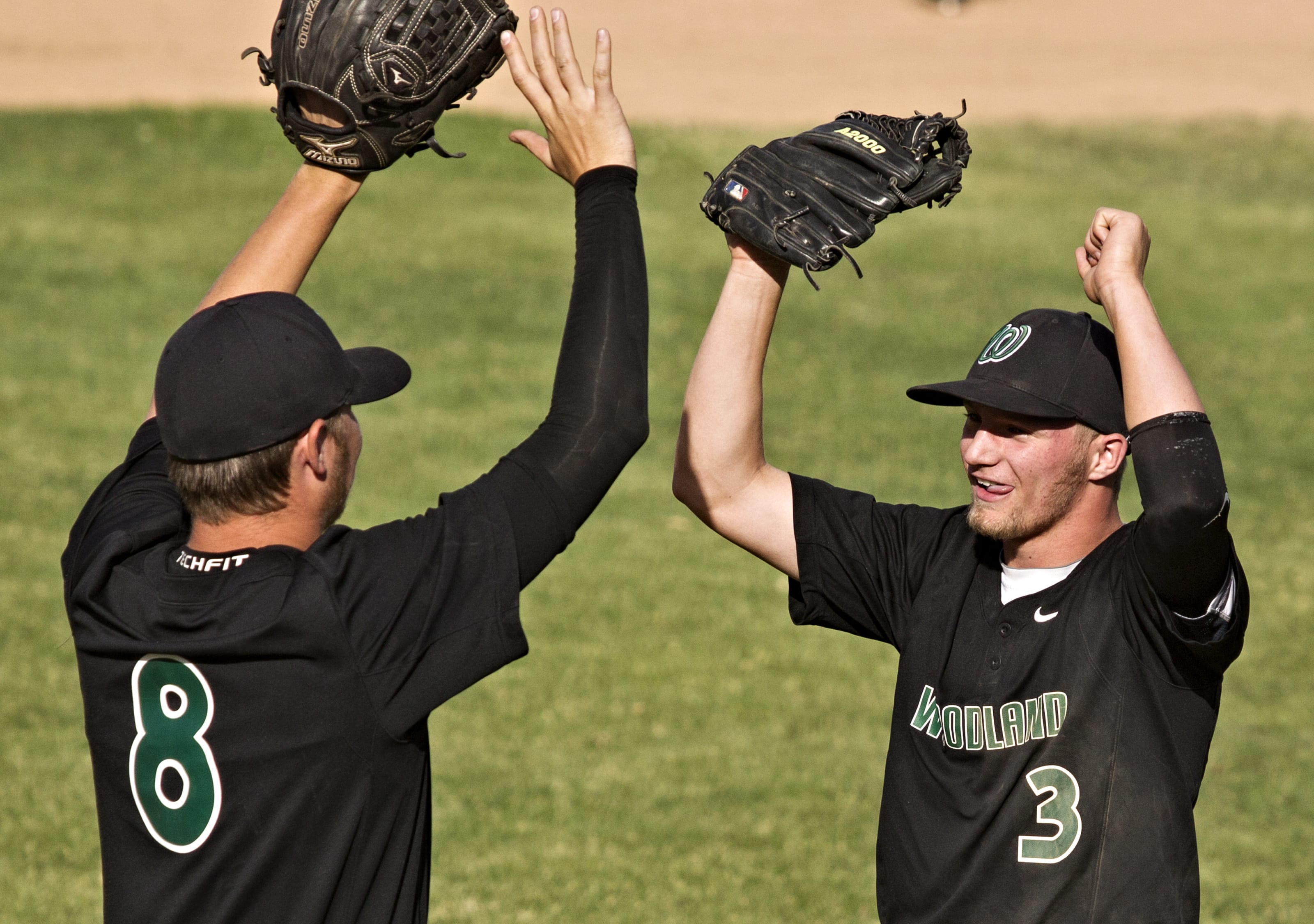 Woodland's Colton Lucas, left, and Trevor Huddleston celebrate after the Beavers' 4-0 victory against Kiona Benton during the Class 1A state baseball semifinals at Yakima County Stadium on Friday, May 30, 2014.