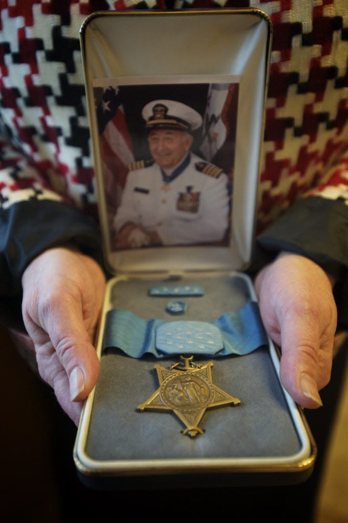 Penny Ross holds a Medal of Honor which was awarded to her father, Donald K. Ross, for his actions during the attack on Pearl Harbor in 2012. The ribbon, but not the medal, was taken in a burglary earlier this year.