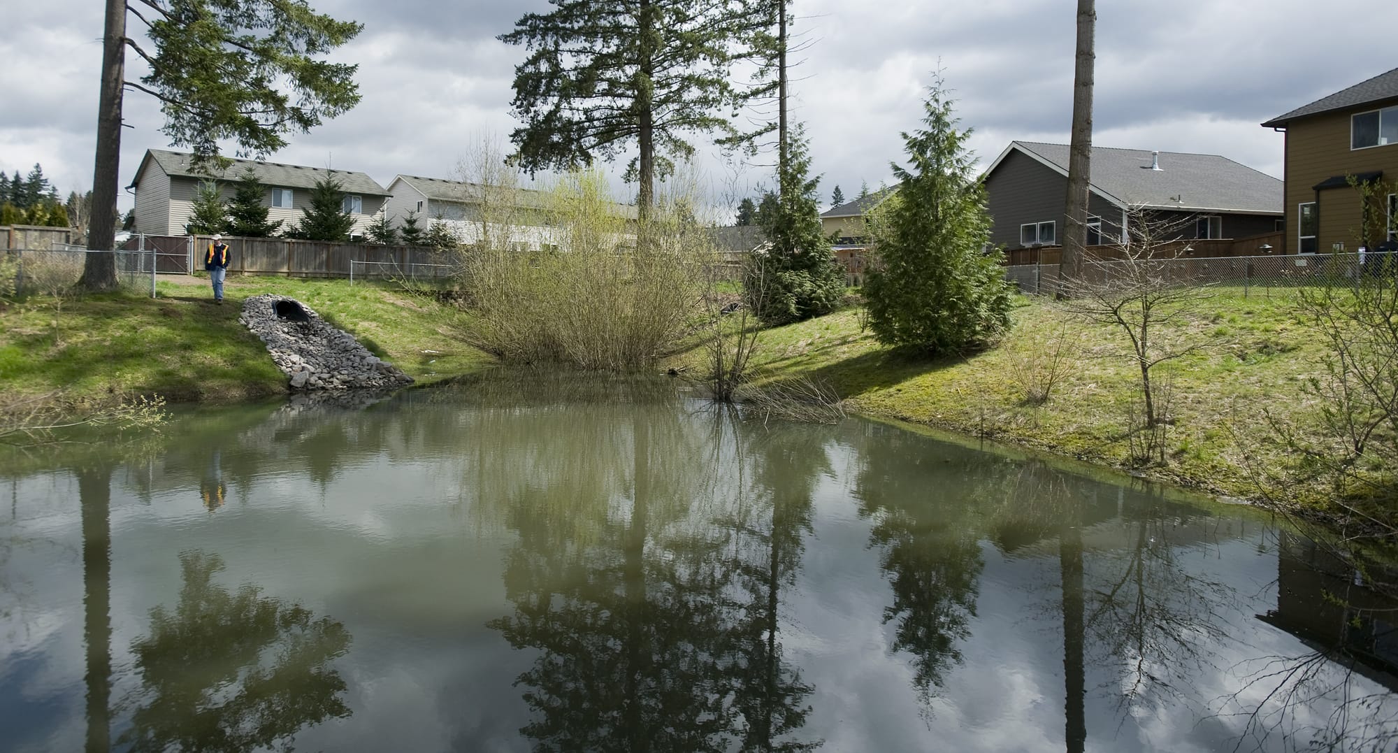 Cary Armstrong, Source Control Specialist with the Clark County Department of Environmental Services, shows a well maintained stormwater site in a Vancouver neighborhood, in 2011.