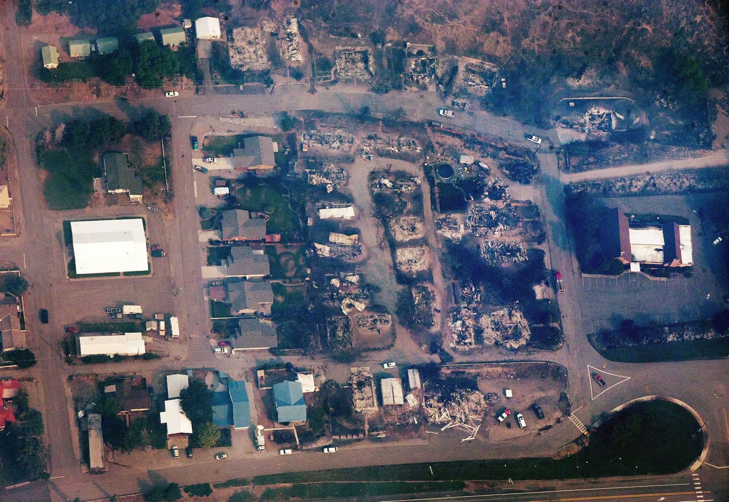 This aerial photo shows a Pateros, Wash. neighborhood that was destroyed by fire on Friday, July 18, 2014, after the Carlton Complex Fire swept through town Thursday night.  Authorities say the wildfire has already burned about 100 homes and prompted the evacuation of Pateros, home to about 650 people in Okanogan County. A hospital in nearby Brewster was also evacuated as a precaution.