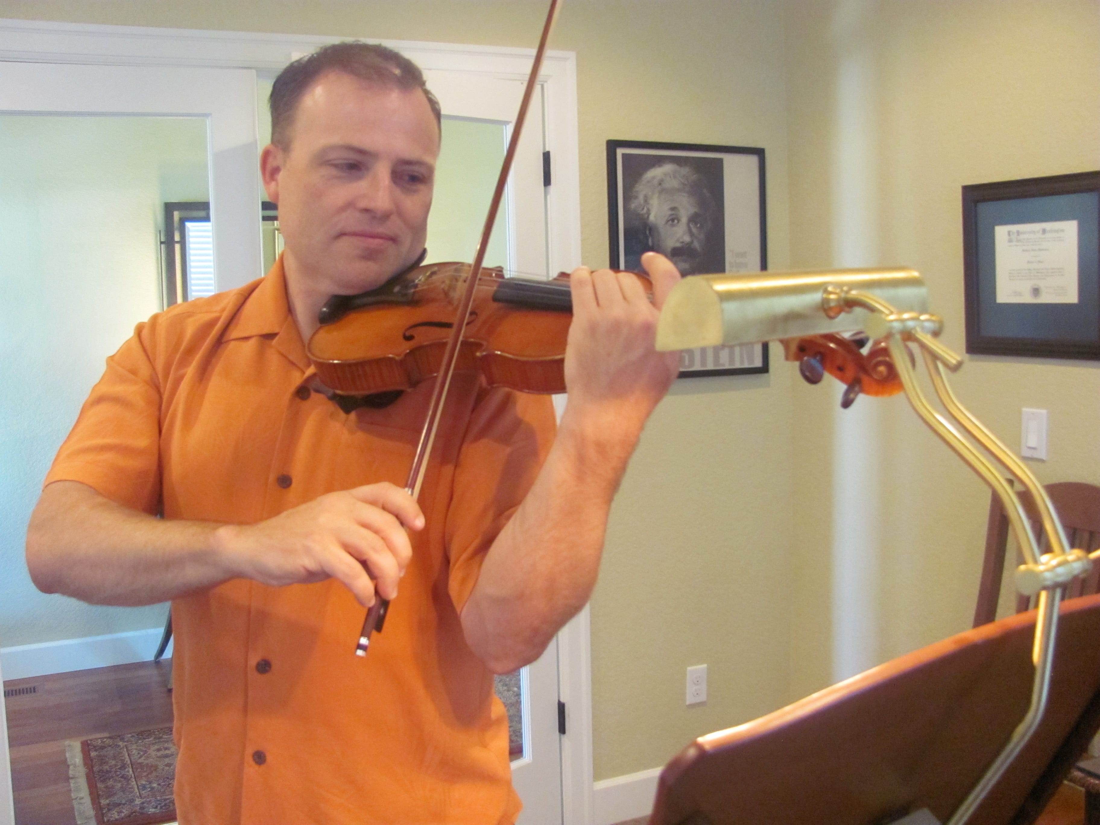 Matt Mandrones practices playing his violin at home in Camas. He said there is a poster of Einstein in his studio, because the physicist was a deep thinker and he played the violin. Mandrones is a member of several orchestras in the region. He is a string orchestra teacher with the Evergreen School District and is also available to teach private violin lessons.