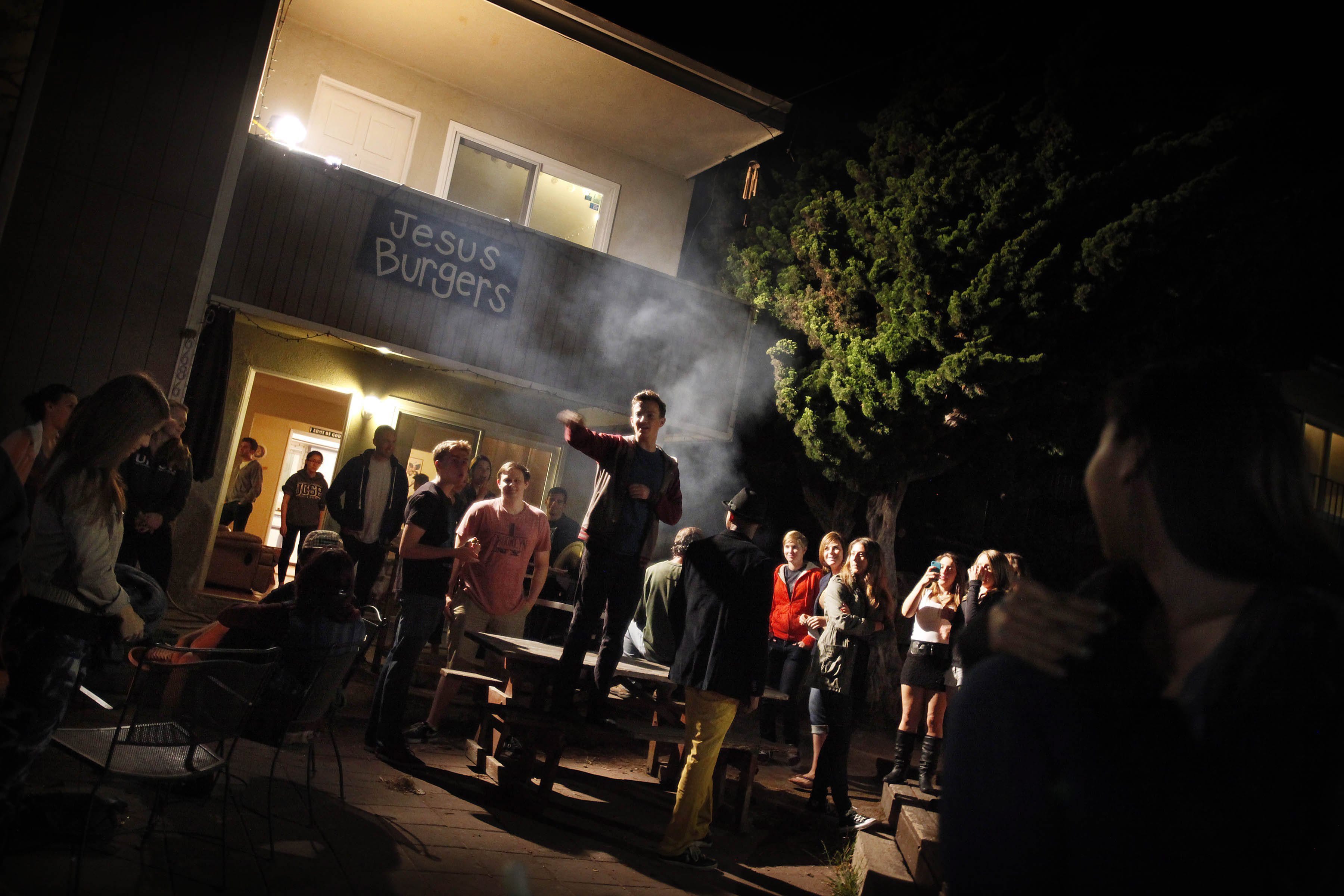 Students eat burgers and mingle at the Jesus Burgers house in May in Santa Barbara, Calif.'s Isla Vista neighborhood.