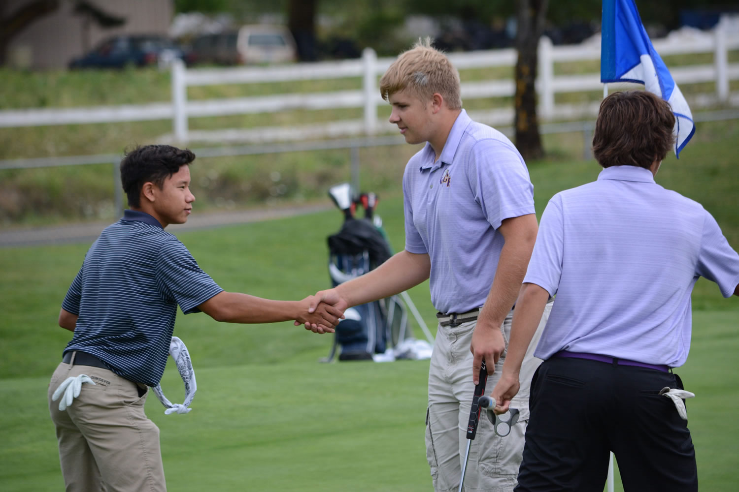 Skyview's Zach Peros, left, and Columbia River's Spencer Long shake hands after completing their round Tuesday at Tri-Mountain Golf Course. The teams tied at 158 in the first high school sports event of the season in Clark County.