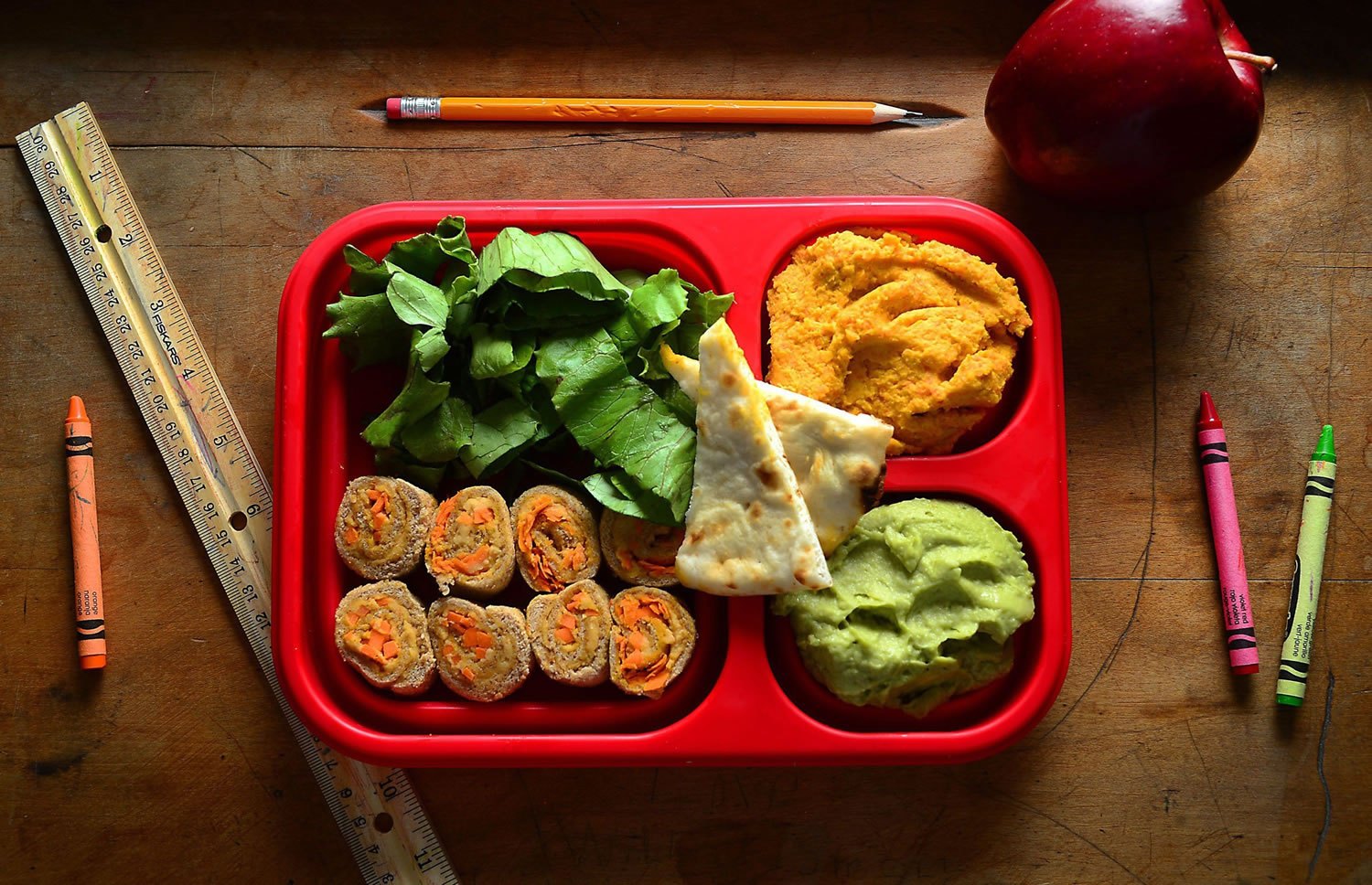 This lunchbox serves up appealing hues and nutritious veggies: pita wedges with colorful hummus dips made with carrots, avocado and beets, along with carrot hummus &quot;sushi&quot; rolls.