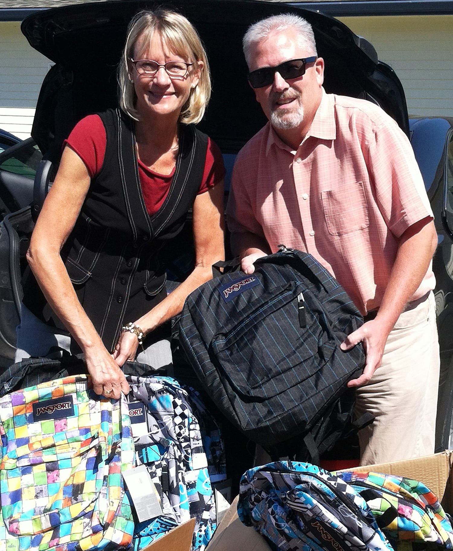 Dawn Tarzian and Mike Nerland, superintendents of the Washougal and Camas school districts, delivered 220 backpacks to school administrators to distribute to children in need.