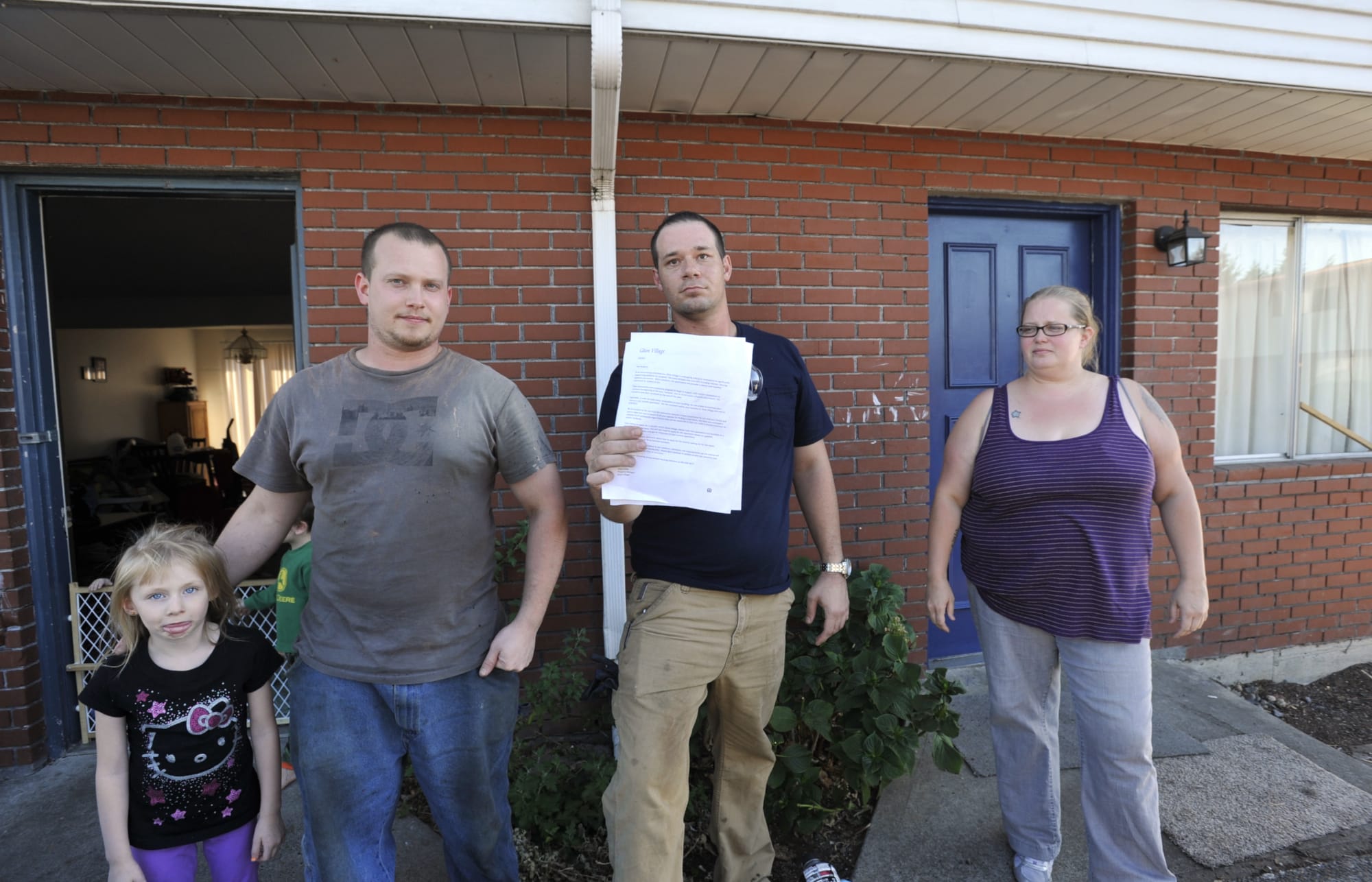 From left, Lilly Corder, Andrew Rickard, Brian Myers, holding the vacate notice, and Jaimie Lewis at the apartment complex where residents are being progressively issued vacate notices, at 1304 NE 88th in Hazel Dell, Wa., Wednesday Sept 9, 2015.
