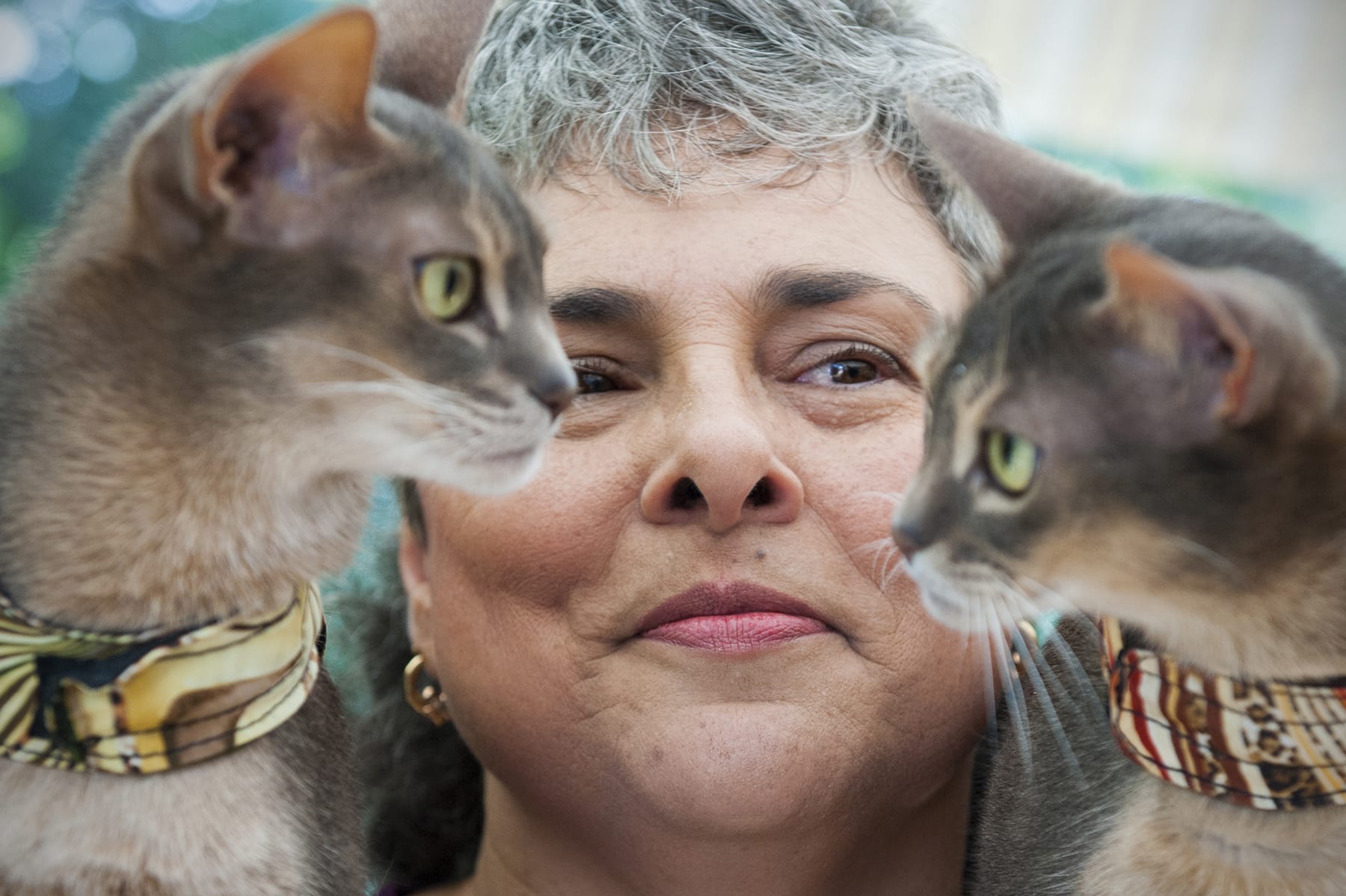 Katherine Frey/The Washington Post
Cat lover Maria Padilla, center, is shown with mother-daughter duo Twyla, left, and Racy Mooner, on Sept. 3 in Reston, Va. Padilla says cats can do anything dogs can do.