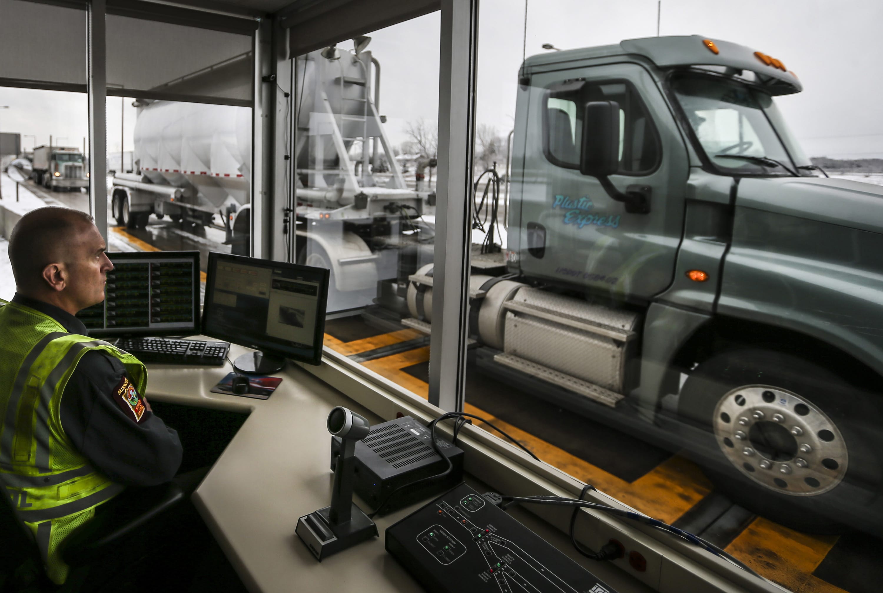 Commercial vehicle inspector Tony Kasella works at the desk monitoring trucks that drove through the St. Croix weigh station on March 23, 2015, in Minneapolis, Minn.