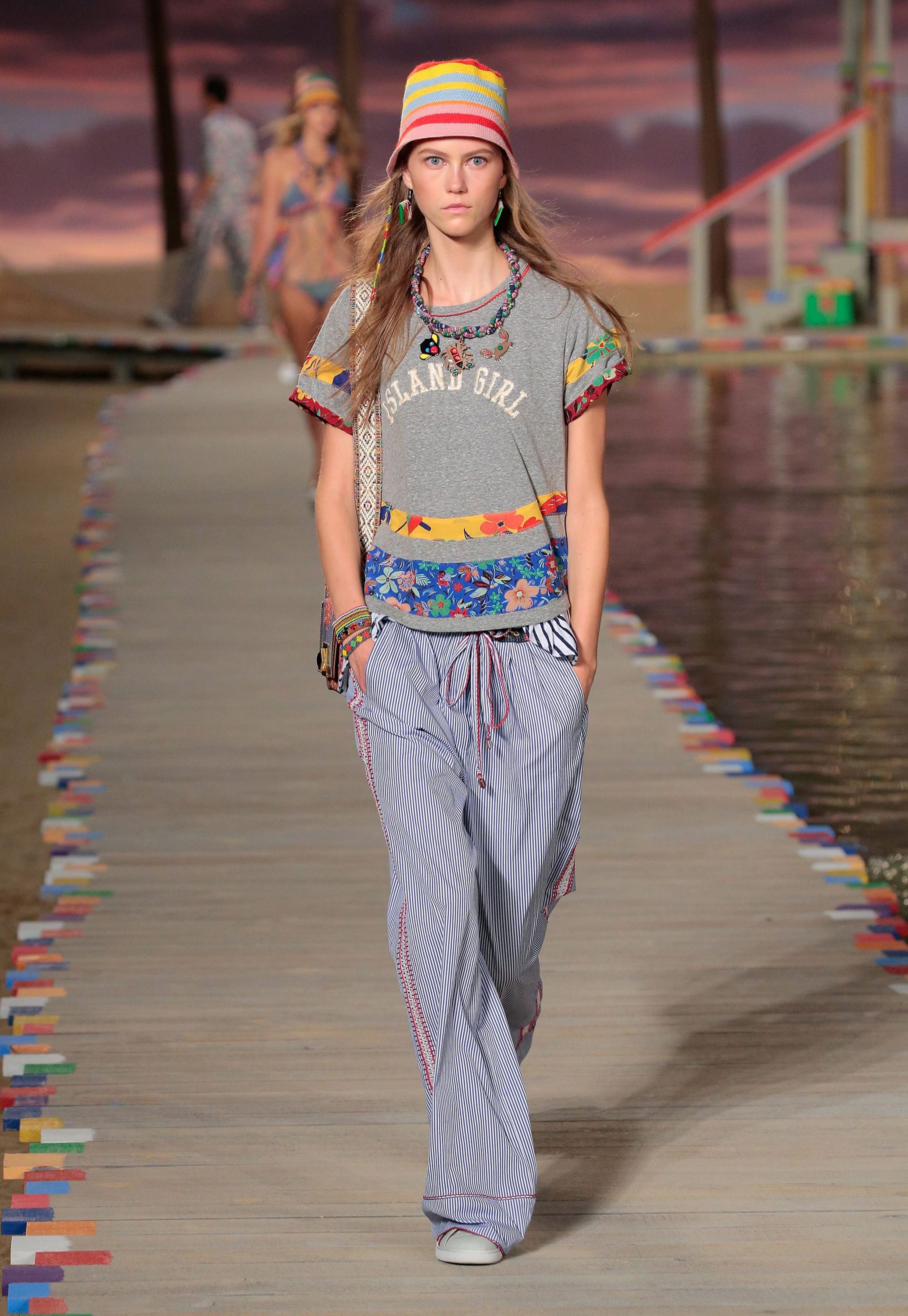 A model walks the catwalk in colorful island life-inspired styles for spring 2016 by Tommy Hilfiger at his runway show at New York Fashion Week.