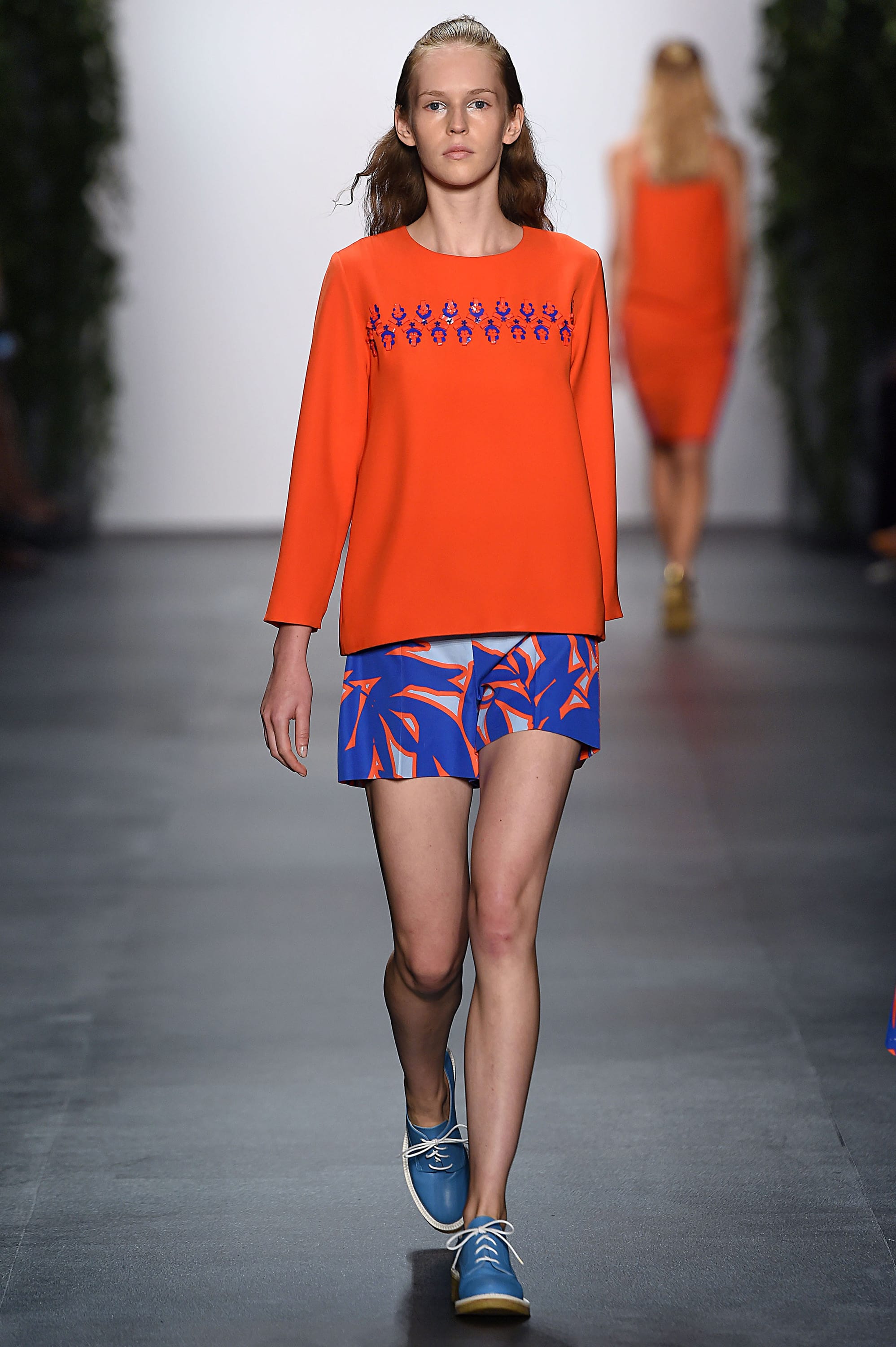 Separates in shades of vibrant fiesta red and rich snorkel blue, two of Pantone's popular color picks for spring, are seen on the runway in the Noon by Noor spring 2016 show at New York Fashion Week.